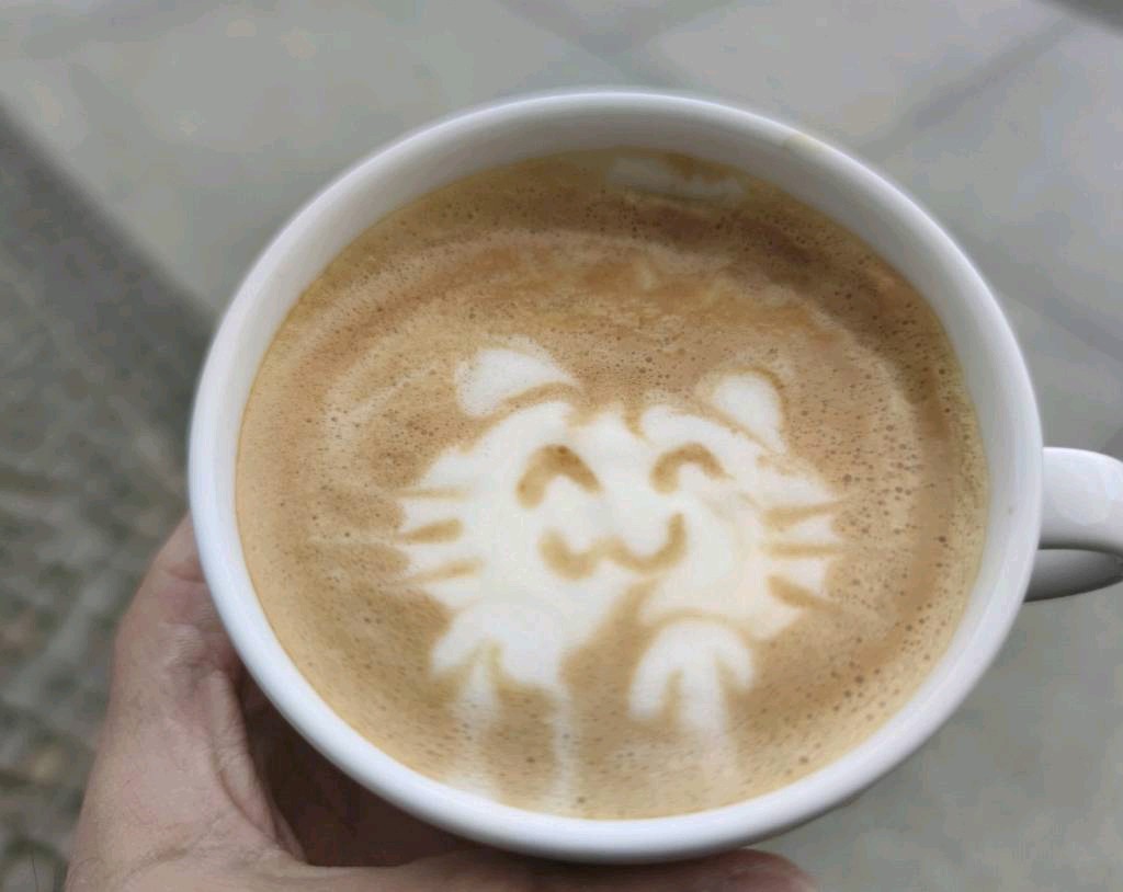 Cat character latte art in a classic cup