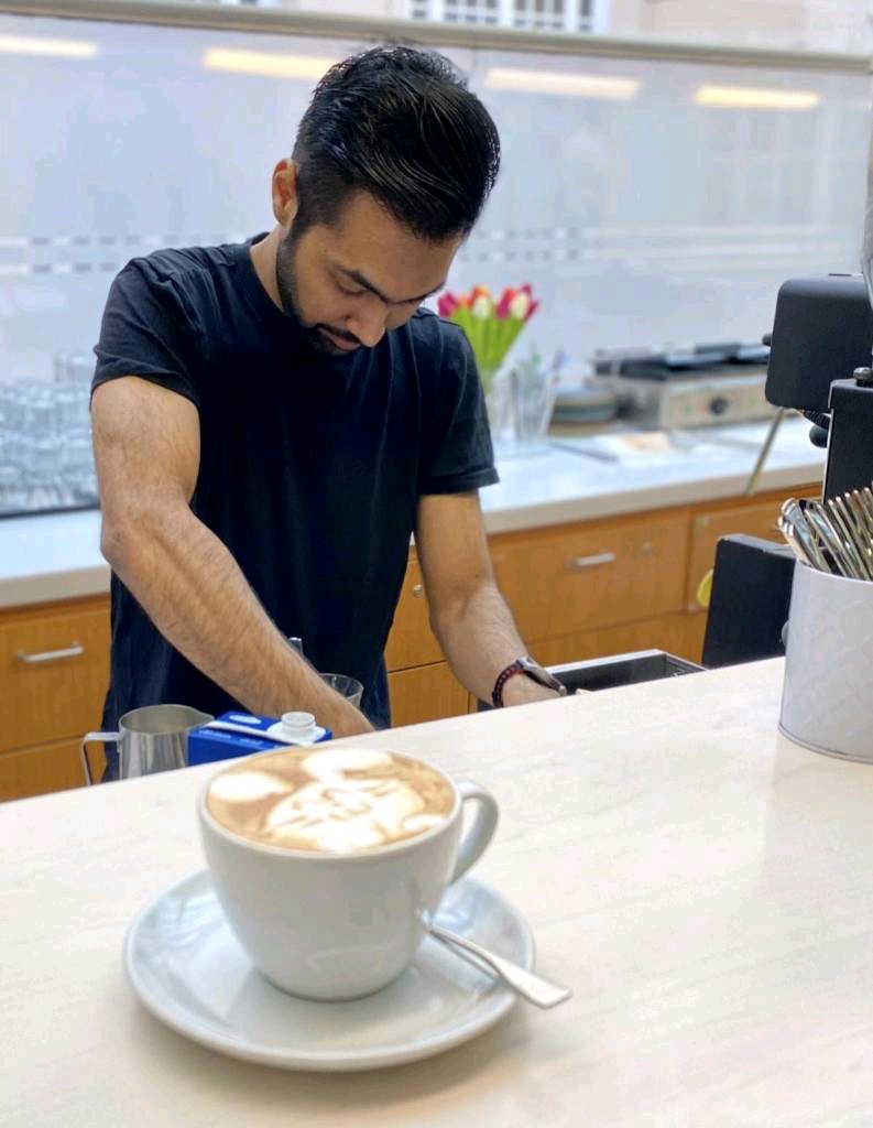 Masood Sultan crafting latte art at the coffee station